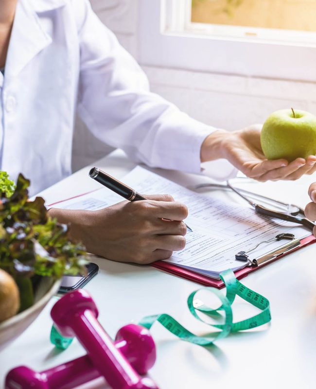 Nutritionist giving consultation to patient with healthy fruit and vegetable, Right nutrition and diet concept