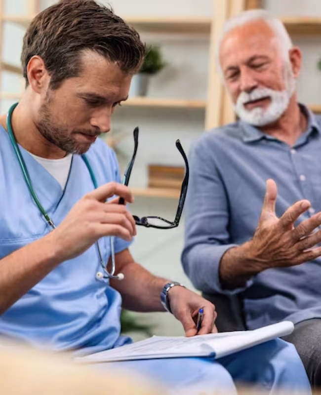 general-practitioner-analyzing-medical-documents-senior-patient-while-being-home-visit_637285-1360